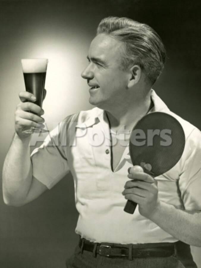 Man With Glass Of Beer And Ping Pong Paddle