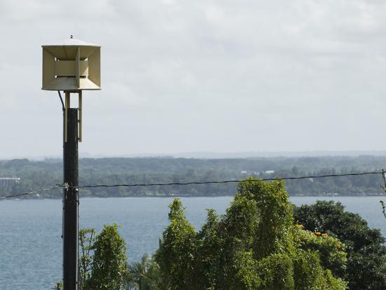 A Tsunami Warning Siren Stands Guard Over Hilo Bay In Hawaii