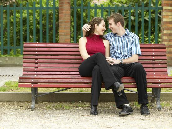 Smiling Couple Sitting on Park Bench' Photographic Print | AllPosters.com