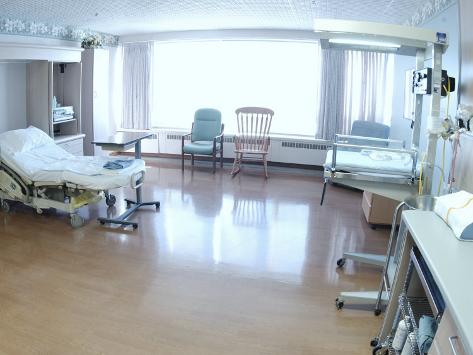 Hospital Bed Chairs And Medical Equipment Arranged In Empty Hospital Room
