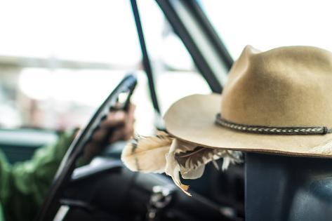 'Cowboy Hat Sits On The Dash Of A Vintage Truck While A Man Drives