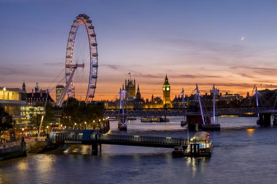 millenium wheel london eye with big ben on the skyline beyond at